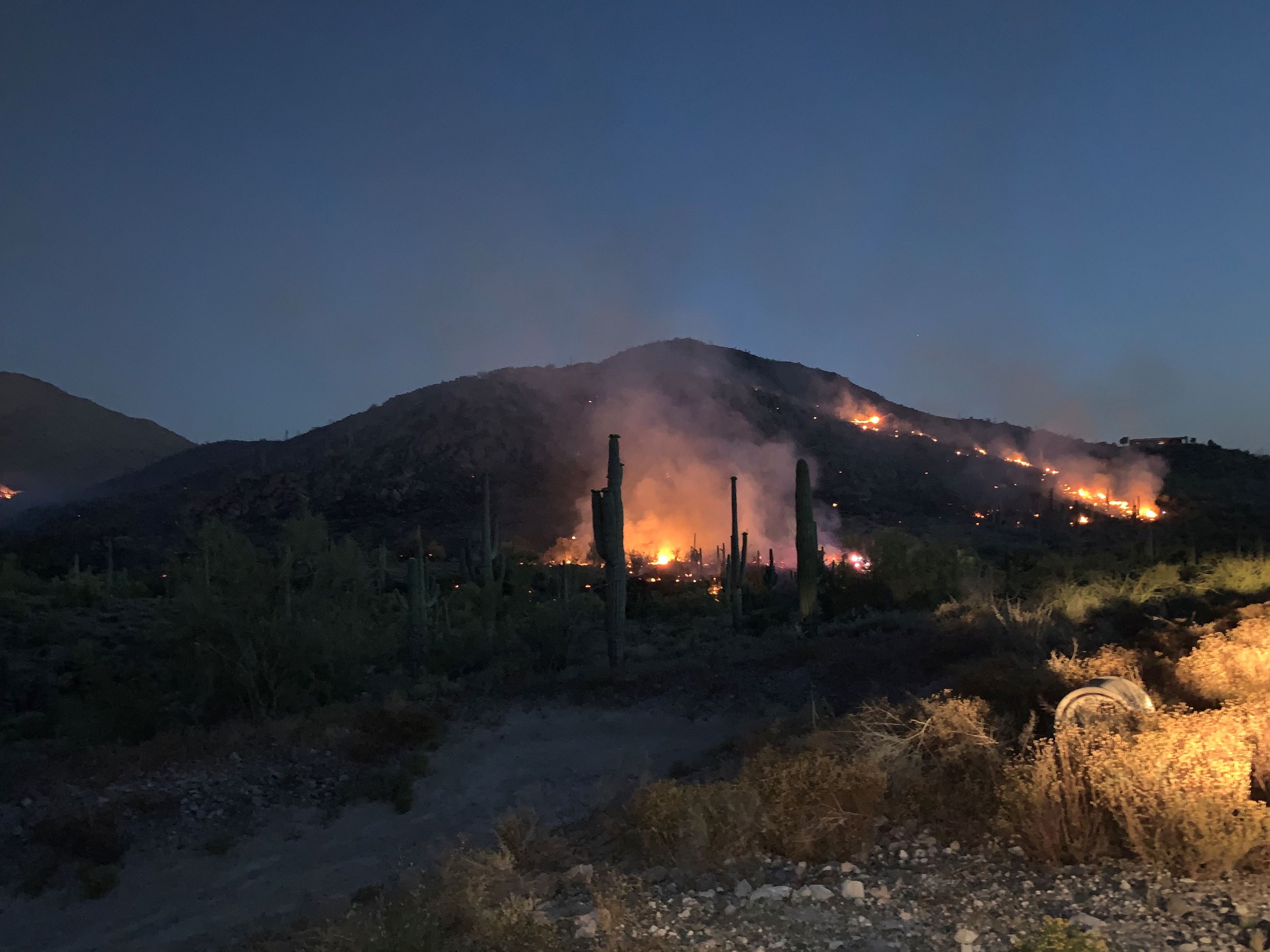 Images of flames along hillside during East Desert Fire
